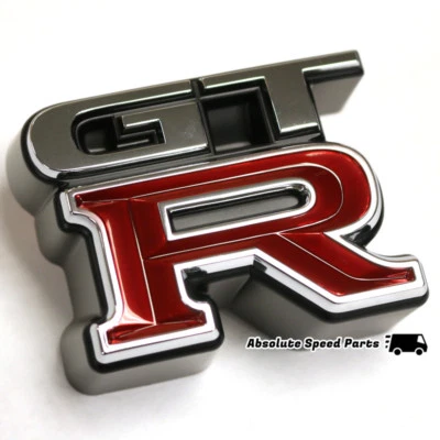 GENUINO Nissan R34 GT-R emblema delantero insignia OEM 62896-AA400 Foto 1 de 2
