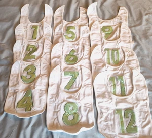 Set of 12 Baby Infant Milestone White Cotton Bibs with GREEN Satin Numbers - Picture 1 of 5