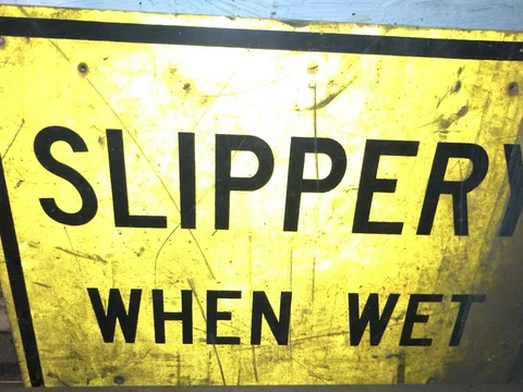 Heavily Dirty Vintage “Slippery When Wet” Sign Cover