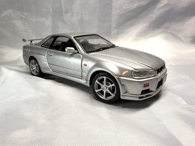 NIssan Skyline GT-R R34 Diecast car in silver 1:24 scale w/opening hood & doors - Image 1 of 4