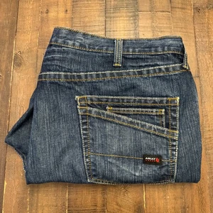 Pantalones de mezclilla de tiro bajo Ariat FR M4 para hombre 50x30 (etiqueta 48x30) azules bolsillos para pantalones de trabajo - Imagen 1 de 21