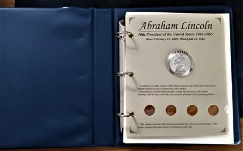 The Abraham Lincoln 2009P Silver $1 Proof coin & 21 Stamp Book Collection Cover