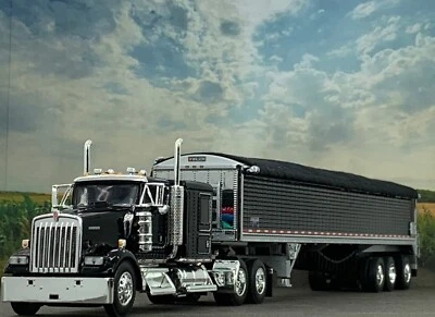 1/64 DCP KENWORTH W900L 60" FLAT TOP W/ WILSON PATRIOT 50' TRI AXLE BELT TRAILER - Image 1 of 4