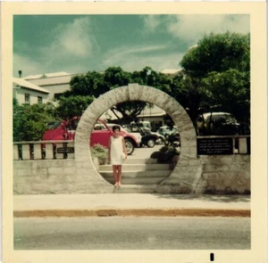 1968 Color Photo Woman In White Stands In Moongate By Parked Cars in Bermuda - Picture 1 of 3