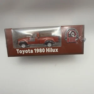 BM Creations 1980 Toyota Hilux - Orange - RHD 1:64 Scale Diecast Car 64B0265 - Picture 1 of 10