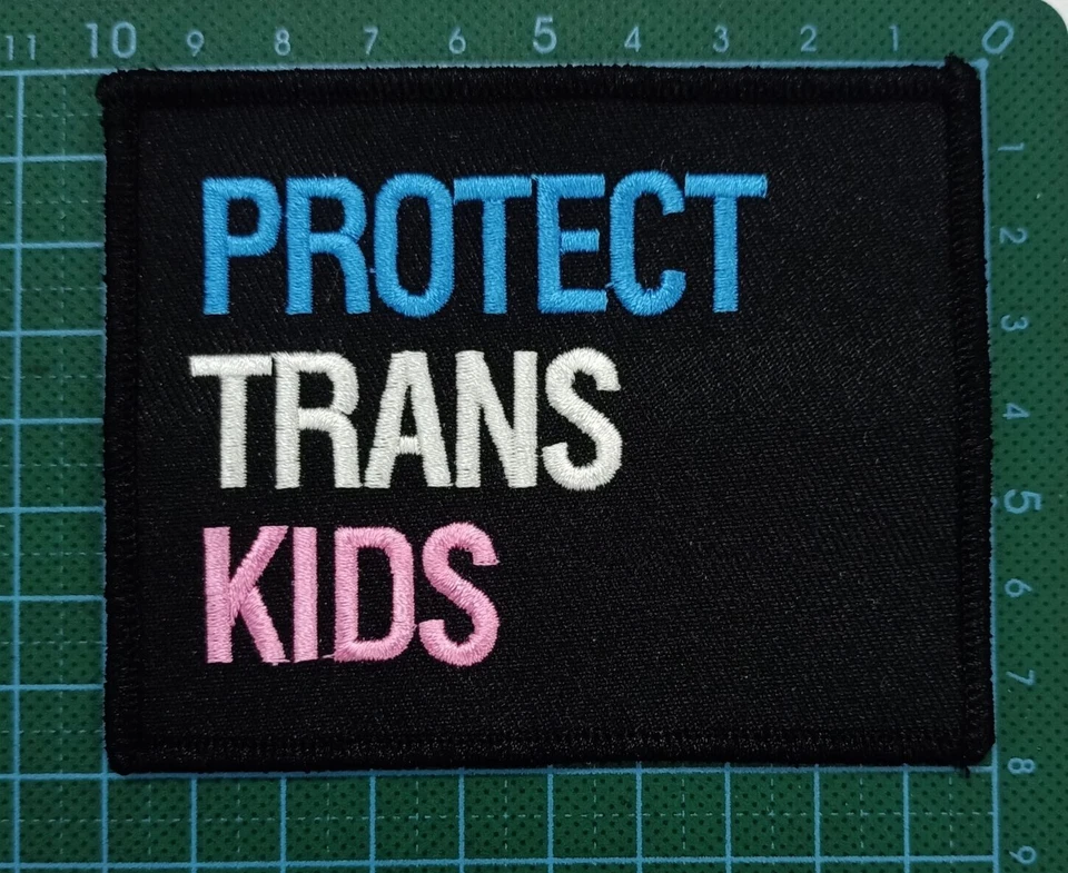 PROTECT TRANS KIDS  4x3" embroidered patch in Transgender Pride colors on black - Image 1 of 4