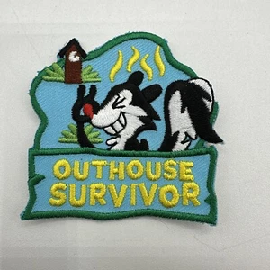 Iron On Patch OUTHOUSE SURVIVOR Skunk Blue Green Trim Camping Outdoors - Picture 1 of 2