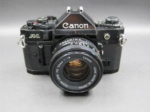 Fotocamera reflex vintage Canon A-1 pellicola 35 mm nera + obiettivo FD 50 mm F/1.8 ((LEGGI)) - Foto 1 di 15
