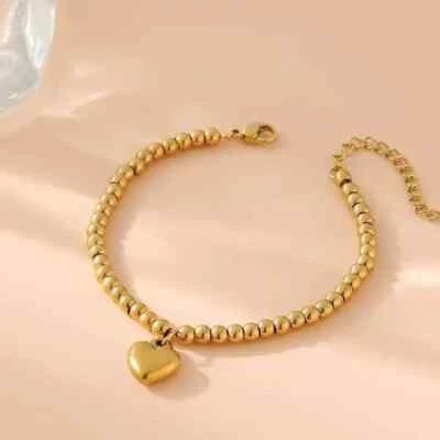 Pulsera con dije de corazón de acero y titanio dorado Foto 1 de 3