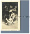 FOUND B&W PHOTO H_5380 BABY AND STUFFED TOY BEAR IN WICKER STROLLER, STORE FRONT