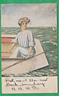 Lady in boat looking at something/ non-linen postcard