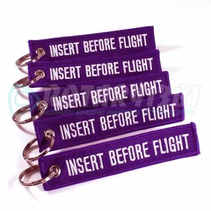 INSERTAR ANTES DEL VUELO LLAVERO PÚRPURA/BLANCO CANTIDAD = 5 PIEZAS ETIQUETAS DE ANILLO - Imagen 1 de 2