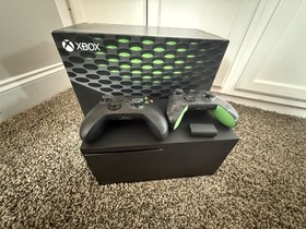 Microsoft Xbox Series X 1TB Console with two Microsoft controllers, battery pack
