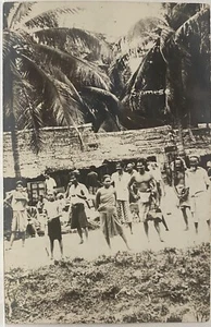 PENANG MALAYSIA REAL PHOTO RPPC GROUP OF PEOPLE NEAR THATCHED ROOF HOUSES - Picture 1 of 3