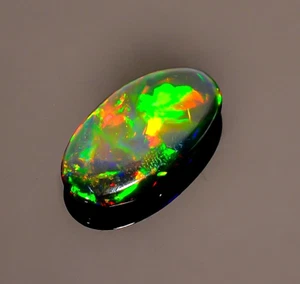 4 Ct Natural Black Ethiopian Oval Cabs Opal Fire Play Opal Gemstone 18X10X3 mm - Picture 1 of 4