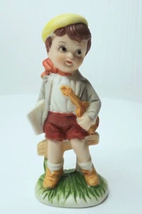 Vintage Little Boy in Yellow Cap with Violin Sitting on Fence Porcelain Figurine - Picture 1 of 3