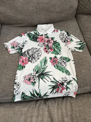 Polo Under Armour Playoff para hombre estampado floral mediano - blanco con hojas verdes/rosas Foto 1 de 4