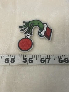 Christmas Grinch Hand Holding Red Ornament Iron On Patch Cute New - Picture 1 of 3