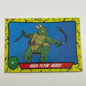 1989 Topps TMNT Teenage Mutant Ninja Turtles #37 ¡Héroe de alto vuelo! Miguel Ángel - Imagen 1 de 2