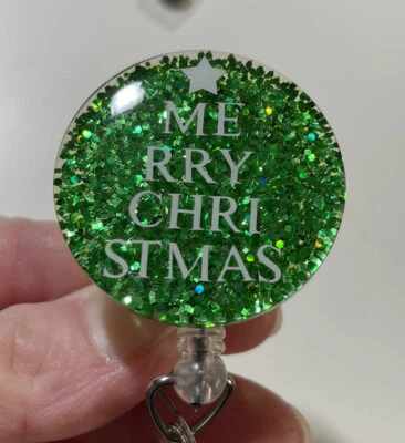 Carrete de insignia retráctil brillante "Feliz árbol de Navidad" Foto 1 de 3