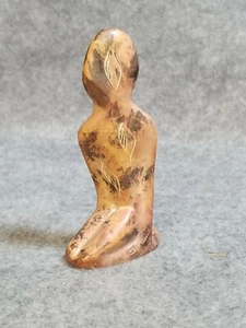 Soapstone Carving of a figure Kneeling, decorated with feathers and swirls - Picture 1 of 3