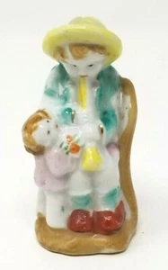 Estatuilla infantil de cerámica de porcelana vintage para madre tocando clarinete marcado Japón - Imagen 1 de 9