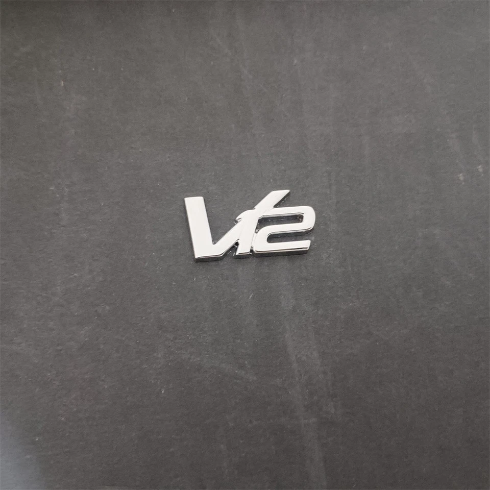 1X Aston martin V12 Metal Emblem Badge AD23-43548-DA - Image 1 of 3