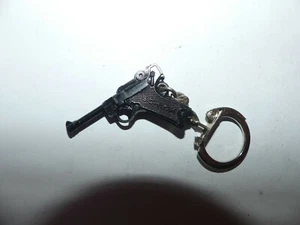 PORTE CLÉ FIGURINE JOUET PISTOLET LUGER NOIR SCHICK - Imagen 1 de 2