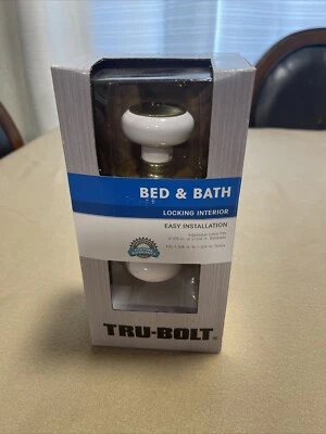 Manijas de puerta interiores con bloqueo de cama y baño TRU-BOLT #1736117 - dorado y blanco Foto 1 de 4