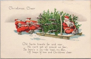 Postal de Navidad Gibson 1921 dos Papá Noel tirando de Santa Claus en trineo de árbol de Navidad - Imagen 1 de 2