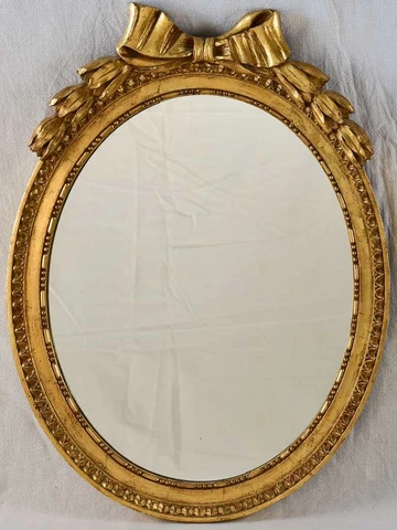 Louis XVI style oval mirror with large bow pediment 20¾" x 28¾" Cover