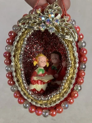 Vintage or retro-style Christmas ornament featuring a diorama Of 2 Kids Caroling - Image 1 of 4