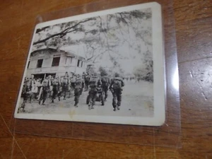 Vintage WW2 Photograph U S army soldiers marching through city Philippines - Picture 1 of 1