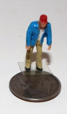 Very Small HO Scale Plastic Figure of a Man in a Blue Coat and a Red Cap - Image 1 of 2