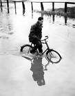 Man cycling along a flooded road at Harrold Bedfordshire 1930s Old Photo