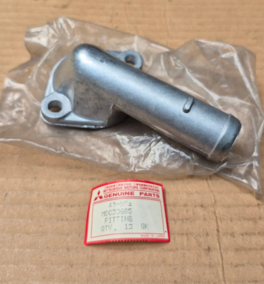 1980-1986 Dodge Colt Plymouth Champ 1.4L 1.5L NOS Mitsubishi THERMOSTAT HOUSING - Image 1 of 3