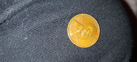 1944 Lincoln wheat penny no mint mark. One Cent Coin, Rim Error āLā In Liberty Cover