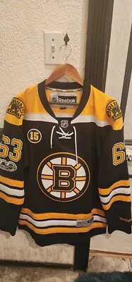 Camiseta deportiva Reebok NHL 100 años Boston Bruins Brad Marchand 63 para hombre mediana Milt 15 Foto 1 de 4