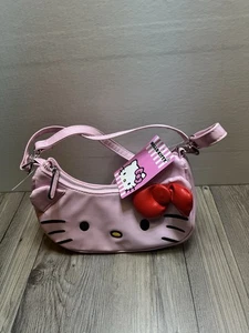 Neu mit Etikett Hello Kitty Face Sanrio rosa mit roter Schleife Kunstleder Umhängetasche Handtasche - Bild 1 von 8