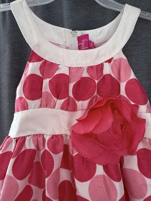 pink polka dot dress featuring a charming flower accent Perfect for any occasion - Image 1 of 4