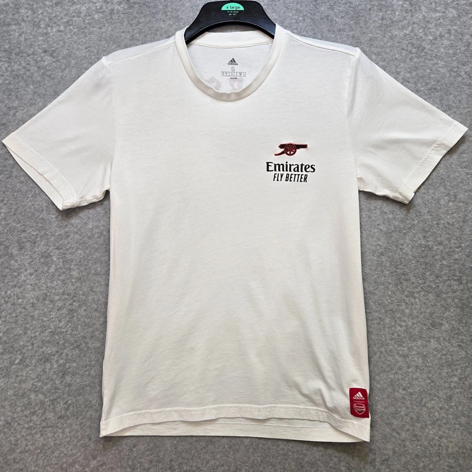 Camiseta The Arsenal Adidas Pequeña Gráfica de Viaje 21/22 Gótica Blanca Cañón 236 Foto 1 de 4