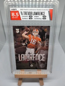2021 LUMINANCE FOOTBALL TREVOR LAWRENCE ROOKIE GOLD PARALLEL RC SP /299 HGA 8.5 - Picture 1 of 4