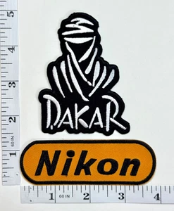 Juego de 2 parches bordados - planchado - carreras - rally - patrocinador - Nikon - Dakar - Imagen 1 de 1