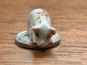 Tiny porcelain pig - sits on a 5 pence coin. - Picture 1 of 6