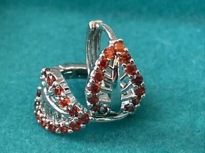Lindos pendientes de aro Huggie redondos con hoja acentuada de circonita roja rellenos de oro blanco de 18 quilates - Imagen 1 de 4