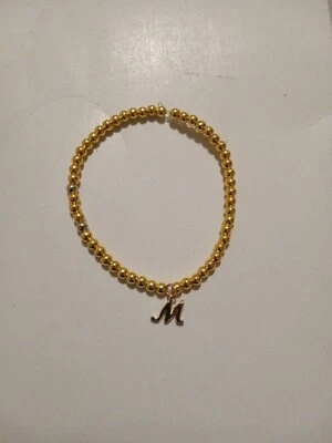 Inicial de cuentas de oro (letra M) Foto 1 de 2