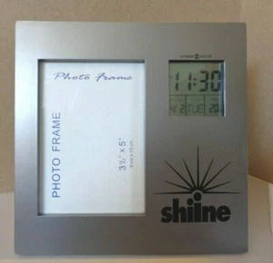 HOWARD MILLER ALARM DATE TIME CLOCK ON PICTURE FRAME - Picture 1 of 2