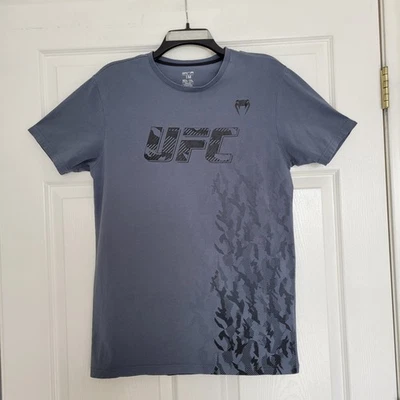 Camiseta UFC Venum Authentic Fight Week Gris Manga Corta Talla Mediana Foto 1 de 4