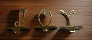 POTTERY BARN JOY STOCKING HOLDERS BRASS PLATED GOLD COLOR MANTLE CHRISTMAS DECOR - Picture 1 of 1