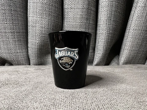 NFL Jacksonville Jaguars Metal Emblem Round Shot Glass 2oz Black Cover